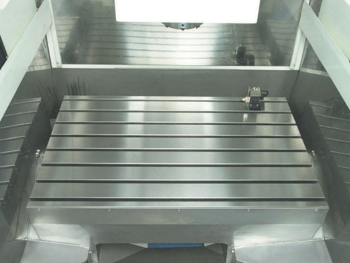 Large precision-machined metal table inside a JigCenter machining system.