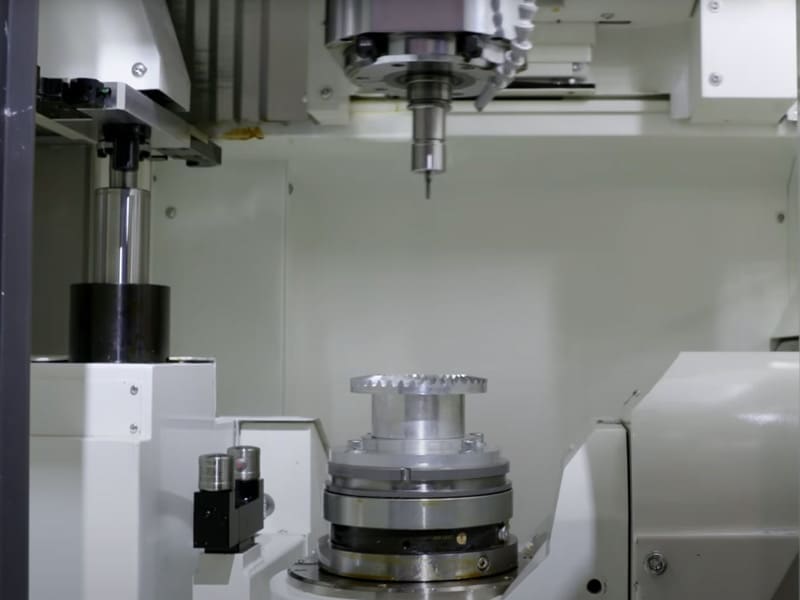 A vertical manufacturing machine with two parts that are used to cut materials.