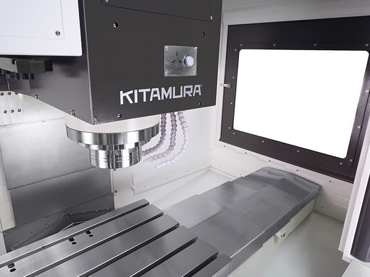 Kitamura CNC machine with a vertical spindle, metal worktable, and control panel.