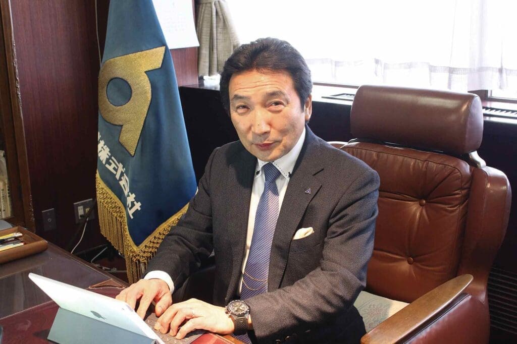 Dr. Aki Kitamura behind desk.